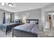 Comfortable bedroom featuring two beds, natural light, and neutral decor at 10515 Greenhead View Rd, Charlotte, NC 28262