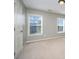 Carpeted bedroom featuring two windows providing ample natural light at 10515 Greenhead View Rd, Charlotte, NC 28262