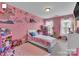 Adorable pink bedroom with plenty of toys and natural light at 10515 Greenhead View Rd, Charlotte, NC 28262