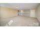 Spacious carpeted bonus room featuring neutral colors, a door to a closet, and access to a second floor landing at 10515 Greenhead View Rd, Charlotte, NC 28262