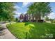 Traditional brick home with lush landscaping and a spacious front yard on a sunny day at 10515 Greenhead View Rd, Charlotte, NC 28262