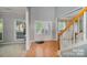 Inviting foyer with hardwood floors, staircase, and natural light streaming through the front door at 10515 Greenhead View Rd, Charlotte, NC 28262