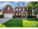 Charming two-story brick home with a well-manicured lawn and inviting front porch at 10515 Greenhead View Rd, Charlotte, NC 28262