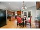 Eat-in kitchen featuring wood cabinets, stainless steel appliances, and glass table with red chairs at 10515 Greenhead View Rd, Charlotte, NC 28262