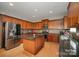 Modern kitchen with wood cabinets, granite countertops, stainless steel appliances, and island at 10515 Greenhead View Rd, Charlotte, NC 28262