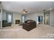 Spacious living room with fireplace, plush carpeting, and comfortable leather sofas at 10515 Greenhead View Rd, Charlotte, NC 28262