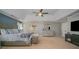 Bright main bedroom with a tray ceiling, furniture, and neutral carpet at 10515 Greenhead View Rd, Charlotte, NC 28262