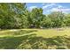 Expansive green backyard featuring lush grass and shade trees at 1103 Oklahoma St, Kannapolis, NC 28083