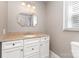 Bathroom with single vanity, granite countertop, tiled floors and a window at 1103 Oklahoma St, Kannapolis, NC 28083