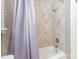 Tiled shower and tub with shower curtain in bathroom at 1103 Oklahoma St, Kannapolis, NC 28083