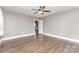 Neutral bedroom with hardwood floors and neutral paint, with doorway that leads to hallway at 1103 Oklahoma St, Kannapolis, NC 28083