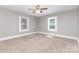 Neutral bedroom with carpet, ceiling fan and two large windows at 1103 Oklahoma St, Kannapolis, NC 28083