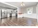Dining room with hardwood floors, gray walls, and open access to the kitchen with stainless appliances at 1103 Oklahoma St, Kannapolis, NC 28083