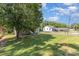 Well-maintained single-story home with expansive front yard, large tree and neutral gray color at 1103 Oklahoma St, Kannapolis, NC 28083