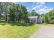 Inviting single-story home with large front lawn, mature trees and neutral gray color at 1103 Oklahoma St, Kannapolis, NC 28083