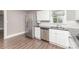 Updated kitchen with stainless steel refrigerator, white cabinets, dark countertops and stainless dishwasher at 1103 Oklahoma St, Kannapolis, NC 28083