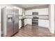 Kitchen featuring modern stainless-steel appliances, white cabinetry, and updated countertop finishes at 1103 Oklahoma St, Kannapolis, NC 28083