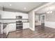Updated kitchen with stainless appliances, white cabinets and dark countertops leading into the dining room at 1103 Oklahoma St, Kannapolis, NC 28083