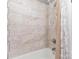 Bathroom features a tub with a shower head and tiled walls at 1103 Oklahoma St, Kannapolis, NC 28083