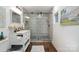 Bathroom with a glass shower, modern vanity, updated fixtures and hardwood flooring at 1135 Brook Path Trl, Denver, NC 28037