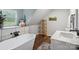 Bathroom featuring a soaking tub, marble-look cabinets, and wood-look floors at 1135 Brook Path Trl, Denver, NC 28037