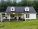 Inviting front porch with a swing and seating, perfect for relaxing and enjoying the outdoors at 1135 Brook Path Trl, Denver, NC 28037