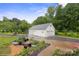 Detached three-car garage with ample driveway space and garden area at 1135 Brook Path Trl, Denver, NC 28037