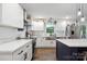 Bright kitchen features white cabinetry, stainless steel appliances, island, and hardwood flooring at 1135 Brook Path Trl, Denver, NC 28037