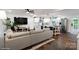Open concept living room with modern decor flowing into the kitchen area at 1135 Brook Path Trl, Denver, NC 28037
