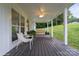 Inviting front porch with chairs, porch swing and wood flooring at 1135 Brook Path Trl, Denver, NC 28037