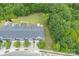 An aerial view of the townhomes featuring a landscaped backyard and easy access to the surrounding wooded area at 11945 Red Rust Ln, Charlotte, NC 28277