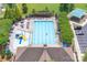 Aerial view of the sparkling community pool with a slide, lounge chairs, and shade, inviting relaxation and recreation at 11945 Red Rust Ln, Charlotte, NC 28277