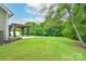 Expansive backyard featuring a spacious lawn and a charming covered patio perfect for outdoor entertaining at 11945 Red Rust Ln, Charlotte, NC 28277
