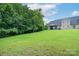 Lush, expansive backyard with a covered patio offers ample space for recreation and outdoor enjoyment at 11945 Red Rust Ln, Charlotte, NC 28277