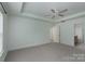 A large bedroom with a ceiling fan and connecting bathroom at 11945 Red Rust Ln, Charlotte, NC 28277