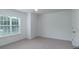 This carpeted bedroom offers a ceiling fan and a bright window at 11945 Red Rust Ln, Charlotte, NC 28277
