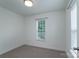 This is a bedroom featuring a window with blinds and neutral carpeting at 11945 Red Rust Ln, Charlotte, NC 28277