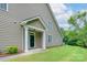 Side entrance with a covered porch featuring white columns and a view of the green lawn at 11945 Red Rust Ln, Charlotte, NC 28277
