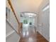 Inviting foyer with hardwood floors, staircase, and archway leading to the living area at 11945 Red Rust Ln, Charlotte, NC 28277