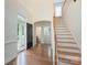 Spacious foyer with wood flooring, staircase, and view of the front door and hallway at 11945 Red Rust Ln, Charlotte, NC 28277