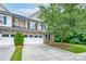 Charming townhome with a two-car garage, stone accents, and well-maintained landscaping at 11945 Red Rust Ln, Charlotte, NC 28277