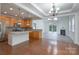 Open-concept kitchen with stainless steel appliances, island, and view of the living area at 11945 Red Rust Ln, Charlotte, NC 28277
