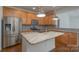Well-equipped kitchen featuring stainless steel appliances, granite countertops, and a central island at 11945 Red Rust Ln, Charlotte, NC 28277
