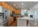 Well-lit kitchen featuring stainless steel appliances, granite countertops, and an island at 11945 Red Rust Ln, Charlotte, NC 28277