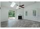 Bright living room with vaulted ceiling, skylights, and sliding glass door to patio at 11945 Red Rust Ln, Charlotte, NC 28277