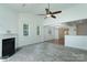 Open concept living room with fireplace, vaulted ceiling, and wood-look tile floors at 11945 Red Rust Ln, Charlotte, NC 28277
