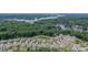 Stunning aerial view of neighborhood homes and water, surrounded by picturesque trees and beautiful nature at 12107 Grey Partridge Dr, Charlotte, NC 28278
