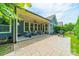 Covered back patio with comfortable seating, string lights, and a grill, perfect for outdoor entertaining at 12107 Grey Partridge Dr, Charlotte, NC 28278