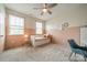 Charming bedroom with a daybed, soft pink accents, and natural light from two windows at 12107 Grey Partridge Dr, Charlotte, NC 28278