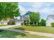 Beautiful blue two-story home with a well-kept lawn, inviting front porch and a two-car garage at 12107 Grey Partridge Dr, Charlotte, NC 28278
